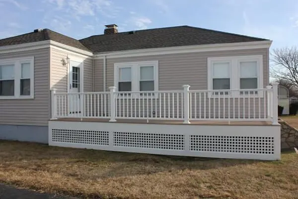White railed deck with lattice skirt on a ranch home