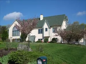 White home with green roof