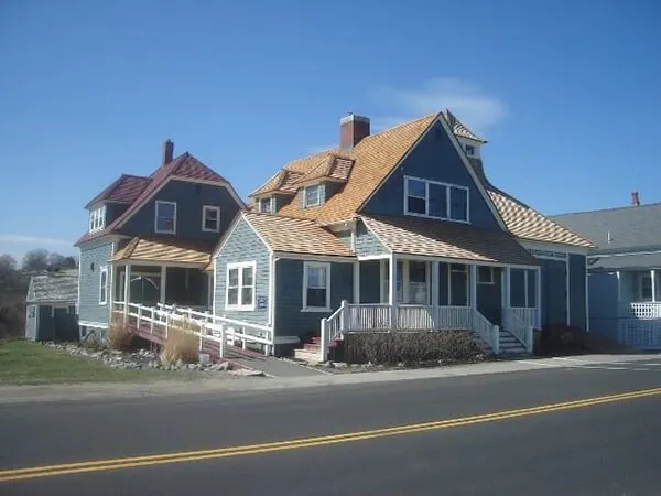Blue shingled homes with cedar roofs