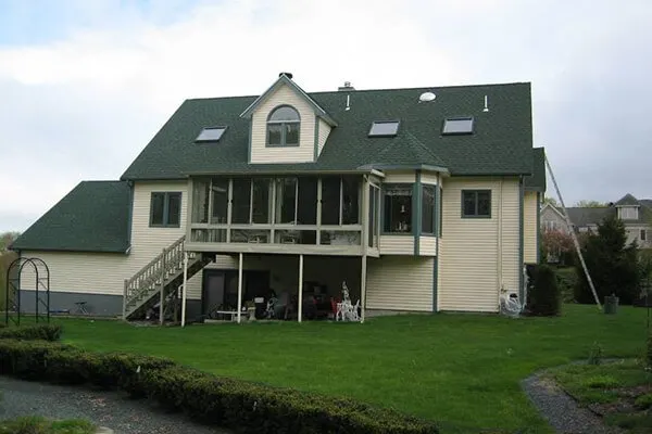 Home with a newly installed roof and covered rear porch